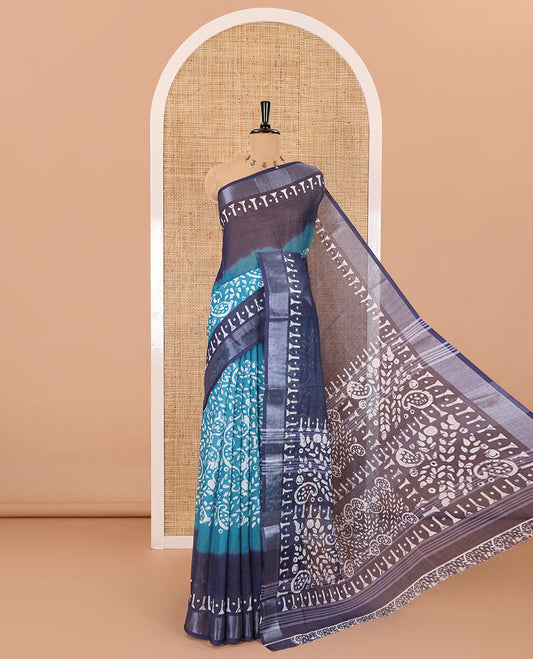 Blue batik style paisleys printed linen cotton saree, contrast batik printed with zari border, batik paisleys printed pallu, and a contrast printed blouse