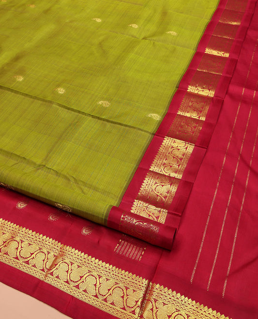 Green Kanchipuram Silk Saree, Decorated with Manga Buttas on Its Body, Complemented by a Contrast One-Sided Korvai Border of Thilakam Mokku, Banaras, Diamond and Floral Creeper Designs, Pallu of Manga Designs, and Comes Without a Blouse