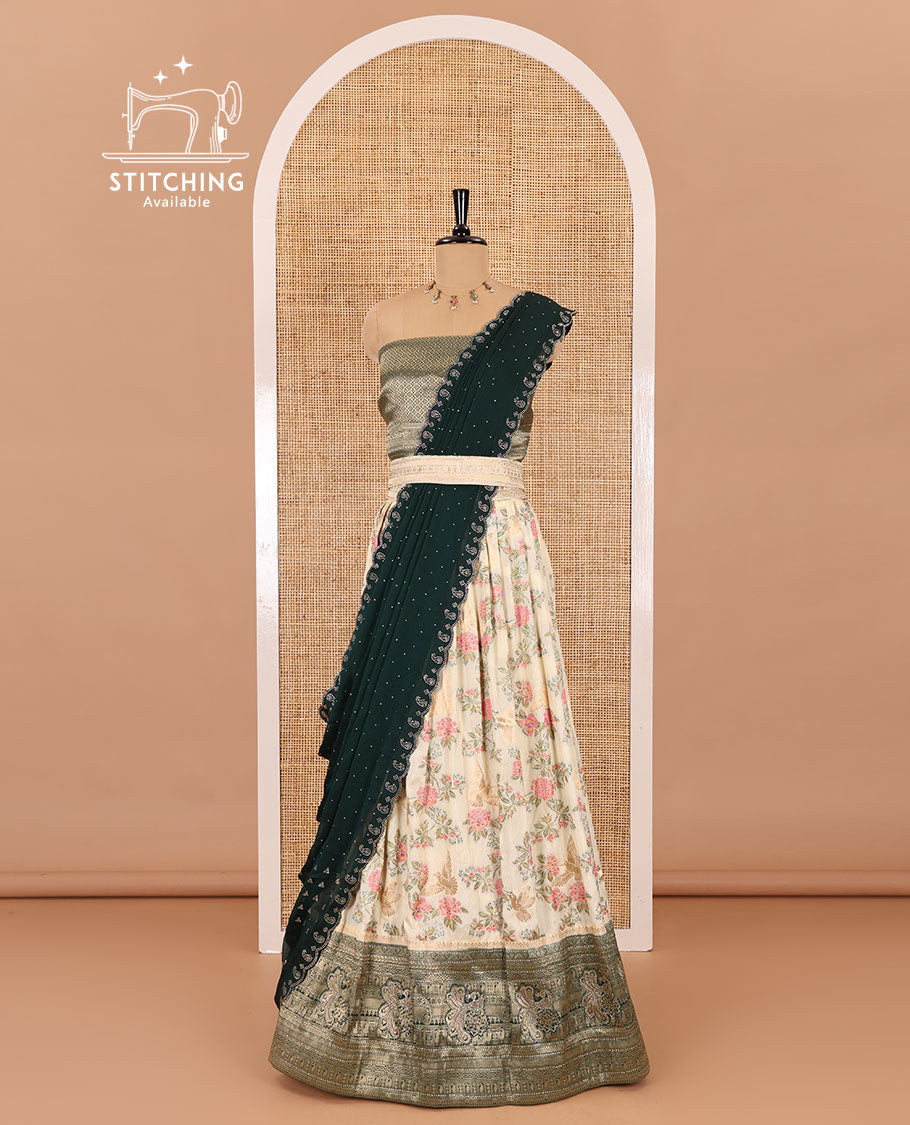 Cream and bottle green half-saree, floral and bird printed nylon viscose crepe top, contrast traditional zari and stone work border, jacquard banaras blouse, and scallop stone work dhavani