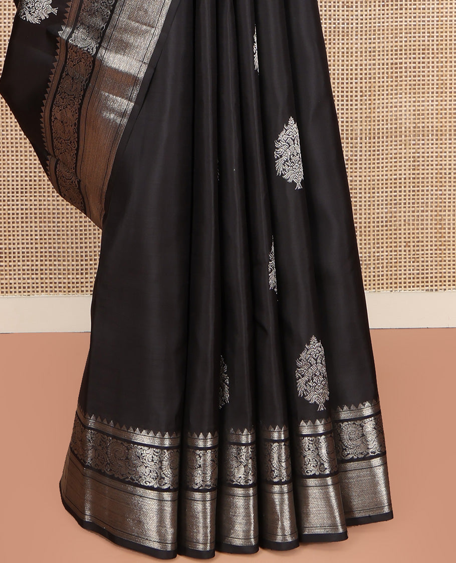 Black Kanchipuram Silk Saree, Dazzled with Zari Buttas All Over Its Body, Highlighted by Zari Border of Rekku, Kathir, Vanki, and Mayil Designs, Pallu of Jaal Design, and Paired with a Matching Blouse