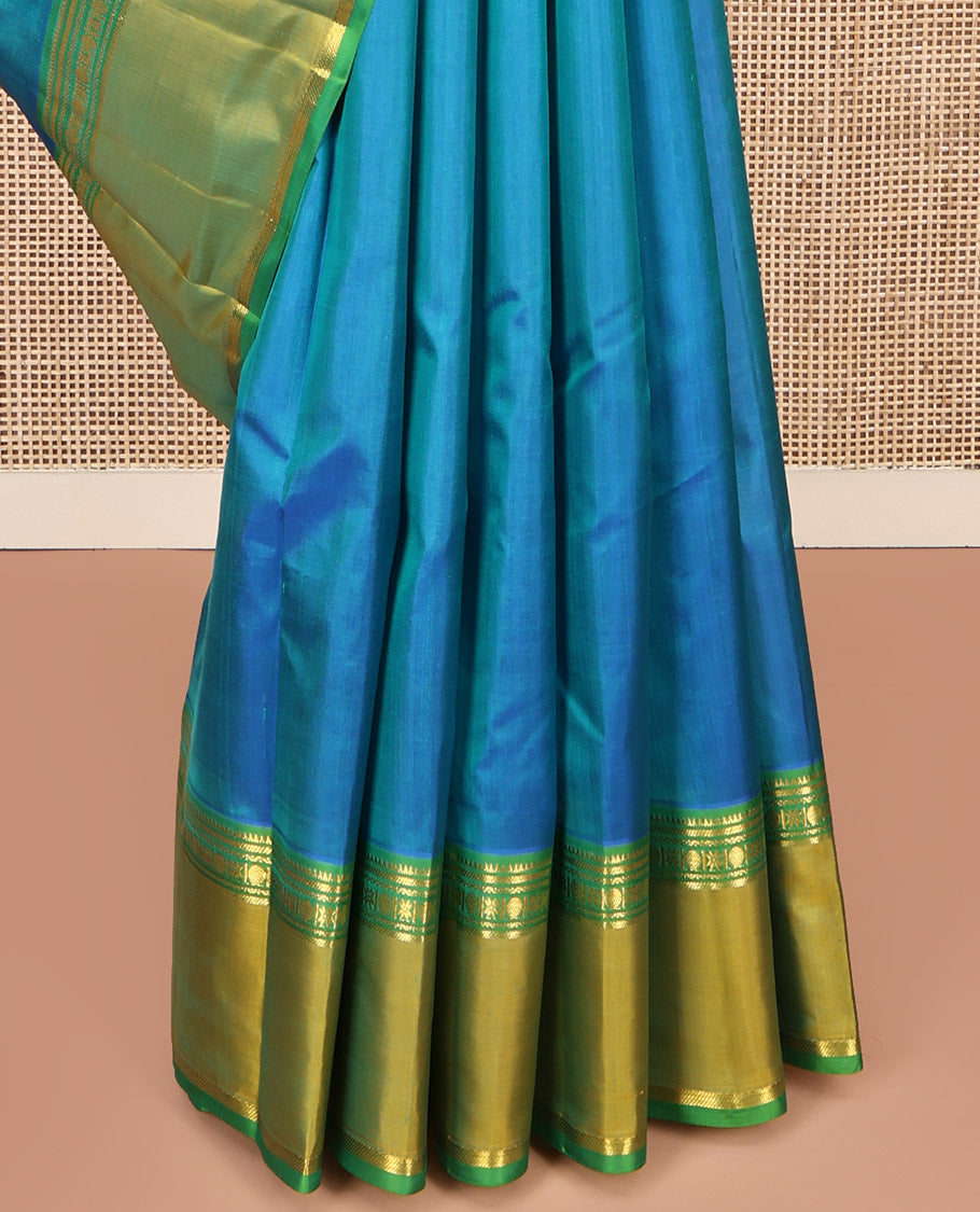 Blue Plain Kanchipuram Silk Saree, Complemented by a Contrast Rettai Pettu Border of Rekku, Banaras, Rudraksham, and Star Designs, Zari Striped Pallu, and Paired with a Contrast Blouse