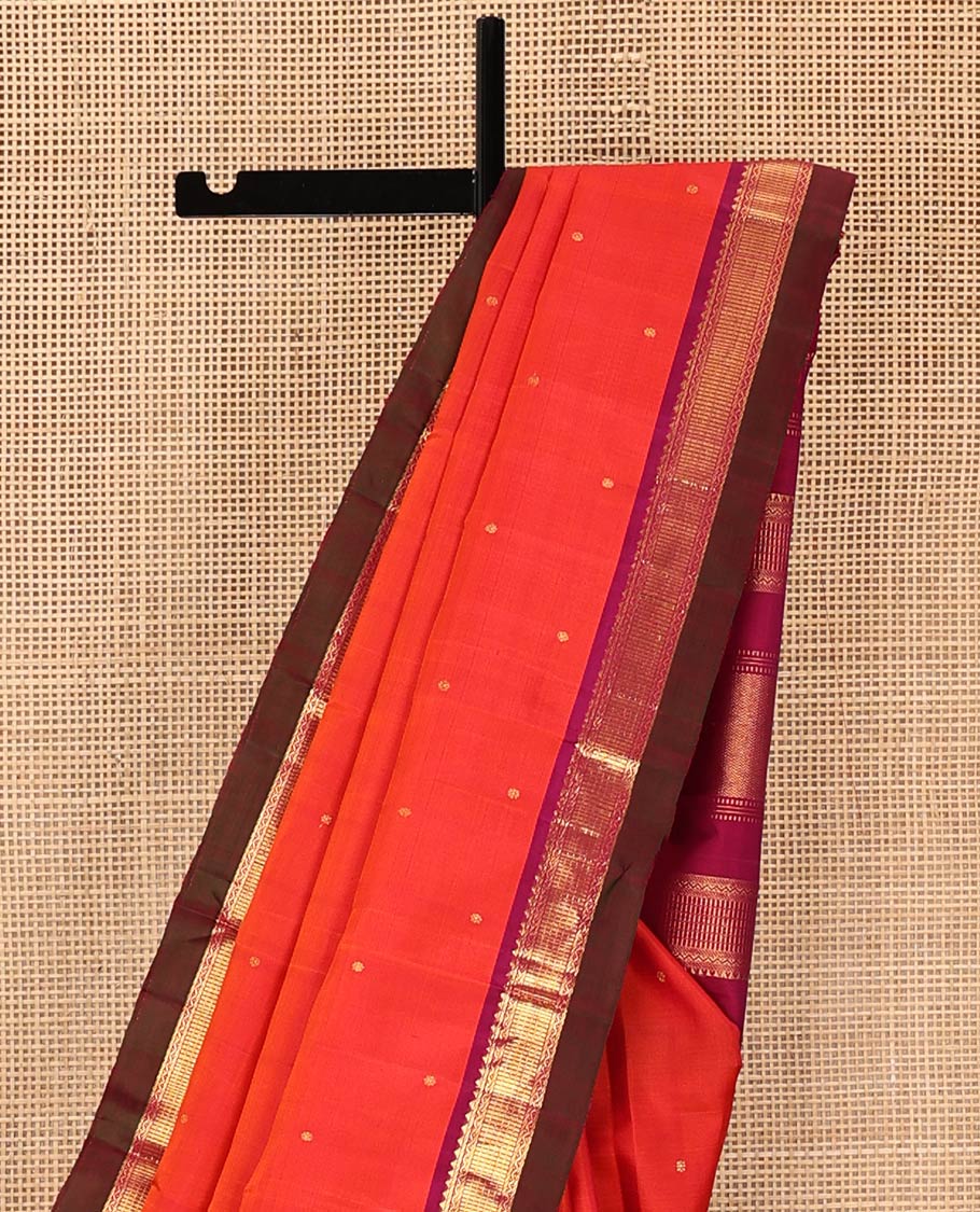 Orange Kanchipuram Silk Saree, Graced with Zari Buttas All Over Its Body, Complemented by Contrast Border of Rekku, Banaras, Neli, and Geometric Designs, Pallu of Traditional Designs, and Paired with a Contrast Blouse