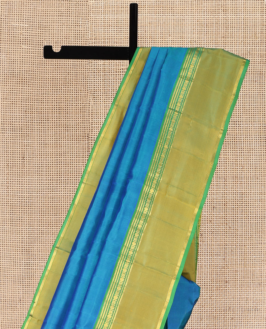 Blue Plain Kanchipuram Silk Saree, Complemented by a Contrast Rettai Pettu Border of Rekku, Banaras, Rudraksham, and Star Designs, Zari Striped Pallu, and Paired with a Contrast Blouse