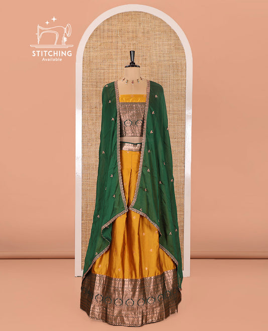 Yellow and Green Semi-Banarasi Half-Saree Prettified with Zari Buttas on Its Skirt, Complemented by a Contrast Traditional Zari Design Steeped Border, Paired with a Matching Blouse, and a Satin Georgette Embroidered Scallop Dhavani