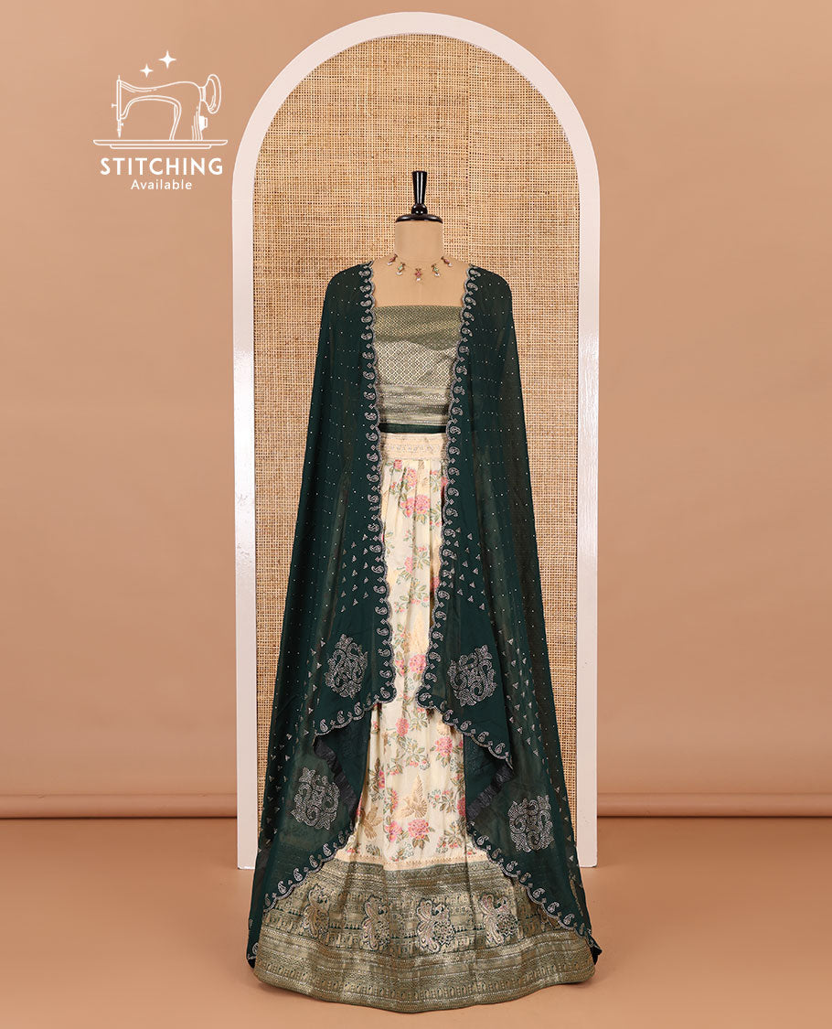 Cream and bottle green half-saree, floral and bird printed nylon viscose crepe top, contrast traditional zari and stone work border, jacquard banaras blouse, and scallop stone work dhavani