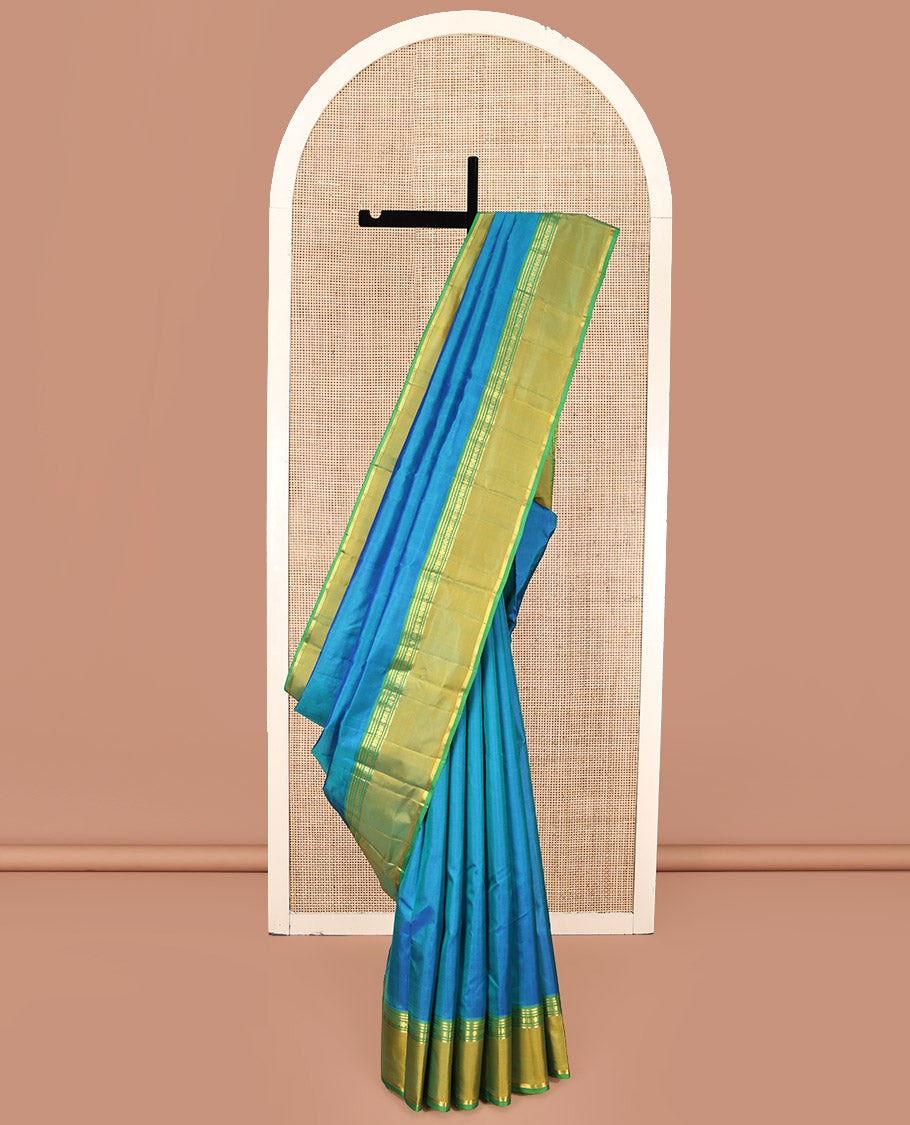 Blue Plain Kanchipuram Silk Saree, Complemented by a Contrast Rettai Pettu Border of Rekku, Banaras, Rudraksham, and Star Designs, Zari Striped Pallu, and Paired with a Contrast Blouse