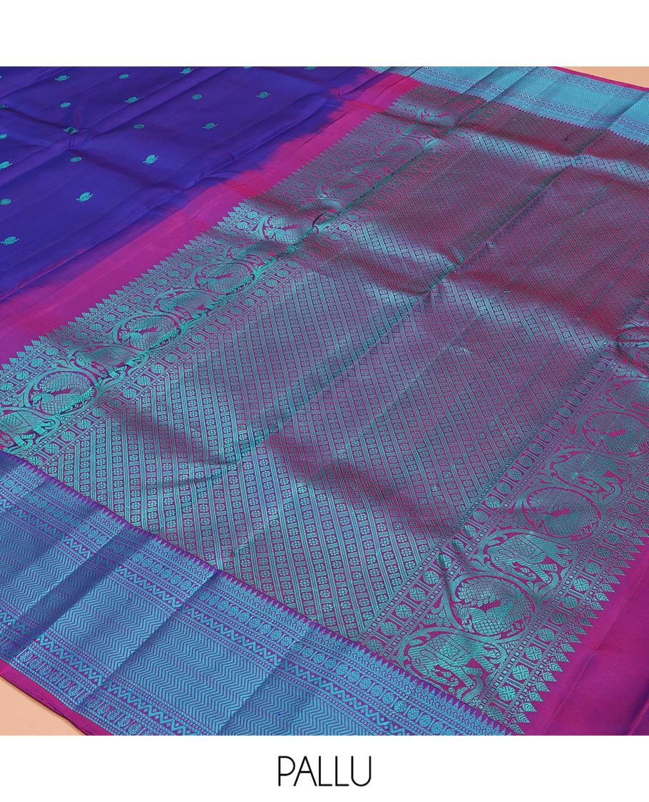 Blue Kanchipuram Silk Saree, Detailed with Mayil-Chakram Buttas All Over Its Body, Complemented by a Contrast Border of Thilakam, Banaras, Muthu, Rudraksham, Neli, and Vanki Designs, Pallu Steeped with Kamalam Designs, and Paired with a Contrast Blouse
