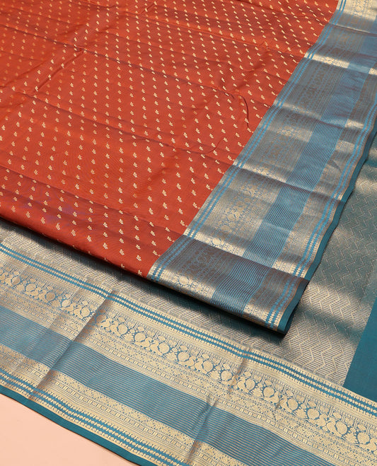 Rust Vasundhara Lite Silk Mix Saree, Elevated with Zari Buttas on Its Body, Complemented by a Contrast Traditional Zari Border of Mayil and Chakram Designs, Pallu Features Chevron Designs, and Paired with a Contrast Blouse
