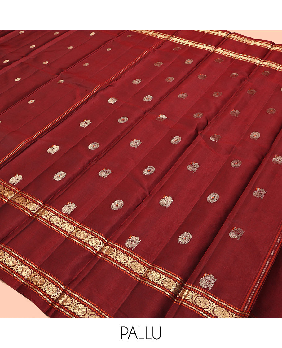 Maroon Kanchipuram Silk Saree, Adorned with Chakram Buttas, Highlighted by a Rettai Pettu Zari Border of Muthu, Banaras, and Cross Kamalam Designs, Mayil-Chakram Pallu and a Matching Blouse