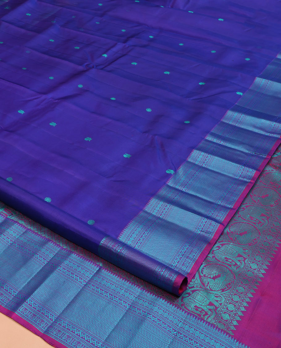 Blue Kanchipuram Silk Saree, Detailed with Mayil-Chakram Buttas All Over Its Body, Complemented by a Contrast Border of Thilakam, Banaras, Muthu, Rudraksham, Neli, and Vanki Designs, Pallu Steeped with Kamalam Designs, and Paired with a Contrast Blouse