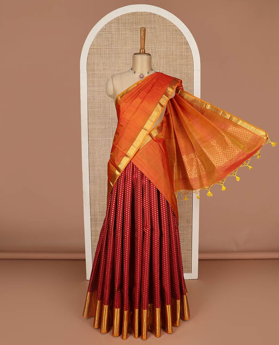 Maroon pure-silk half-saree, zari buttas with contrast traditional zari bordered skirt, zari design blouse, and a mat textured dhavani