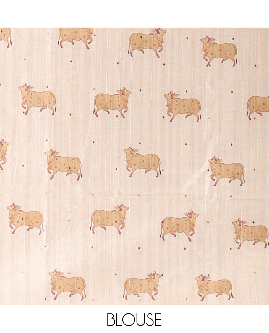 Borderless Cream Semi-Tussar Saree, Artfully Printed with Ancient Human Figurines, Floral, and Pichwai Cow on Its Body, Highlighted by Kalamkari-Style Human Motifs Printed Pallu, and Paired with a Matching Pichwai Cow Printed Blouse