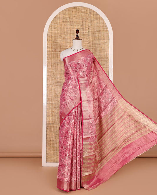 Rani pink scallop design tissue saree, zari striped border, striped pallu, and gleaming matching blouse