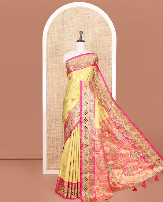 Yellow Vastrakala Silk Saree, Highlighted with Jacquard and Embroidery Work, Complemented by Contrast Zari and Cut Embroidered Border, Gleaming Floral Jaal Stone Work Pallu, and Paired with Contrast Heavy Embroidered Blouse