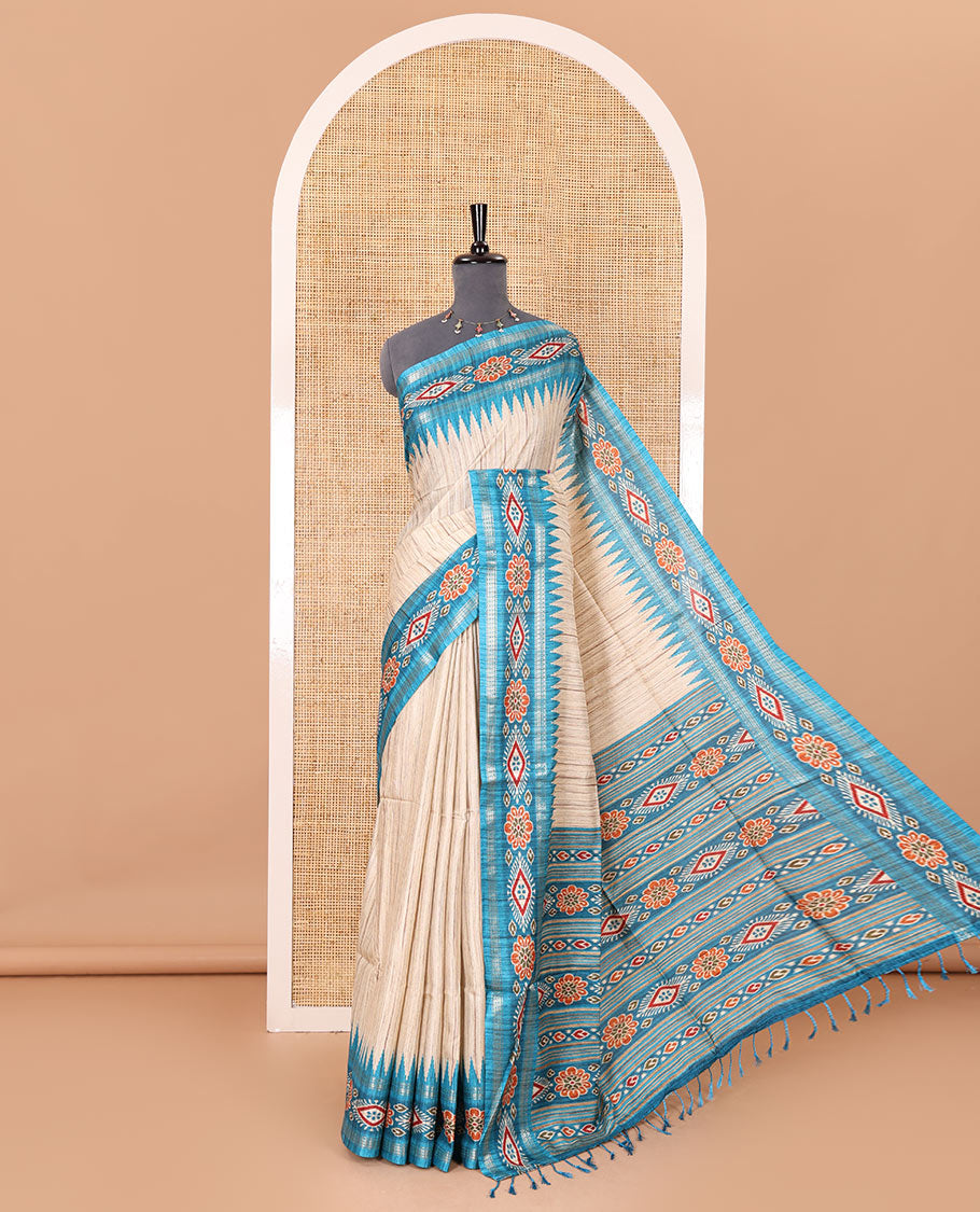 Chikku- blue plain Katan silk saree, contrast ikkat floral-geometric printed temple border, ikkat printed pallu, and ikkat printed blouse