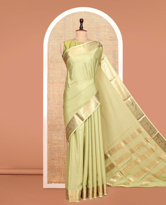 Green Plain Mysore Silk Saree, Highlighted by a Traditional Zari Border of Yaali Designs, Pallu Steeped with Traditional Designs, and Paired with a Matching Blouse