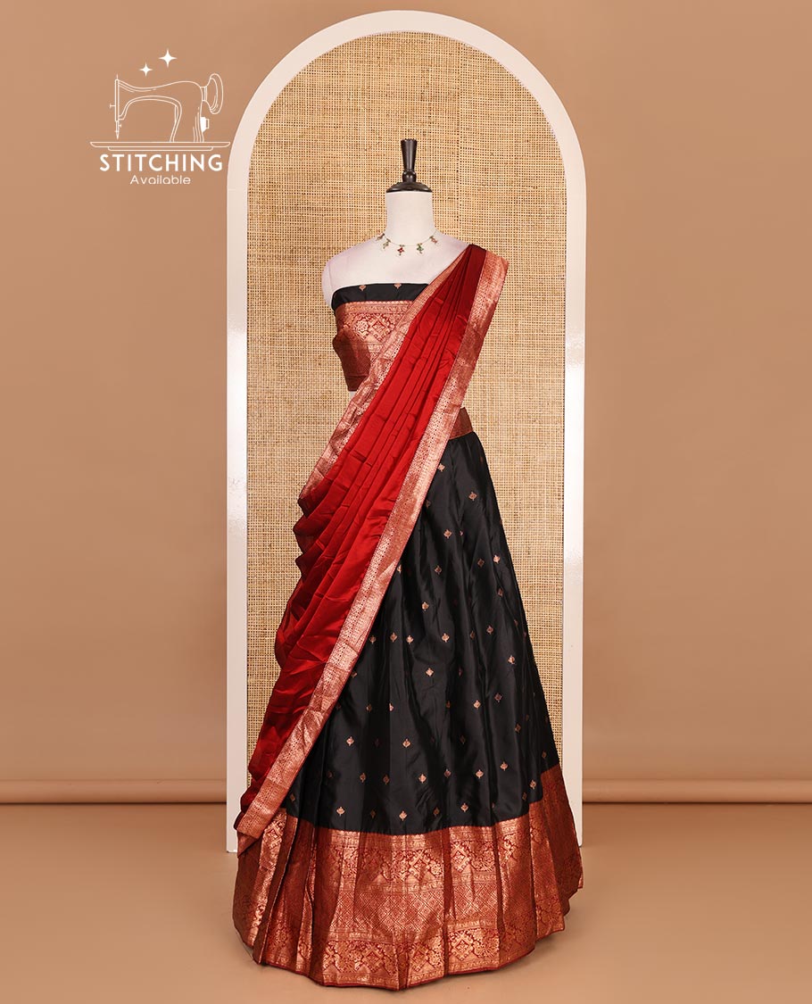 Black taffeta silk half saree, zari buttas with contrast red traditional zari border, matching zari blouse, and contrast plain zari border dhavani