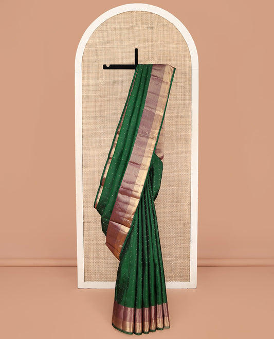 Green Kanchipuram Silk Saree, Steeped with Zari Buttas on Its Body, Complemented by Seppu Rekku Zari Border, Majestically Detailed Pallu, and Paired with a Contrast Blouse