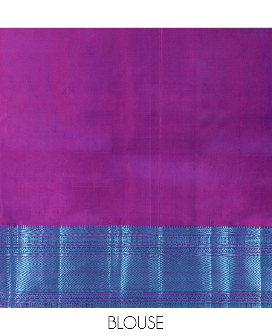 Blue Kanchipuram Silk Saree, Detailed with Mayil-Chakram Buttas All Over Its Body, Complemented by a Contrast Border of Thilakam, Banaras, Muthu, Rudraksham, Neli, and Vanki Designs, Pallu Steeped with Kamalam Designs, and Paired with a Contrast Blouse