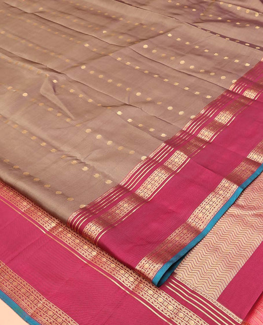 Brown Vasundhara Silk Mix Saree, Enriched with Zari Buttas All Over Its Body, Complemented by Contrast Varisai Pettu Border of Neli, Muthu, Star Kamalam, and Rudraksham Designs, Vanki Design Pallu, and Paired with a Contrast Blouse