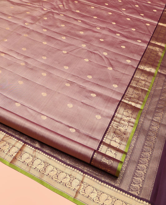Rose Gold Pink Kanchipuram Silk Saree, Prettified with Zari Buttas All Over Its Body, Complemented by a Contrast Border of Mutthu, Mayil Kann, and Mayil Designs, Grandly Jaal Design Decked Up Pallu, and Paired with a Contrast Blouse