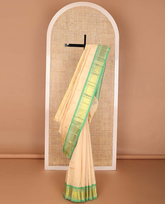 Cream buttas kancheepuram silk saree with contrast border of rekku, muthu, banaras, geometric design & floral buttas pallu