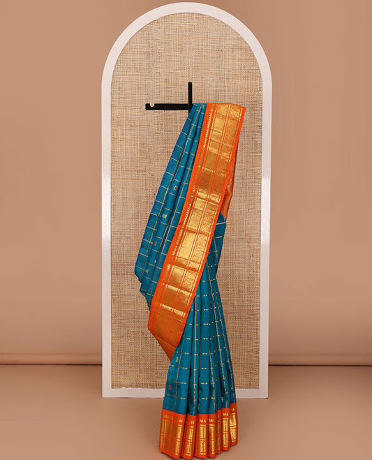 Blue zari buttas enclosed, checked kanchipuram silk saree, contrast one-sided korvai border of thilakam mokku,banaras,jaal & manga & intricate pallu