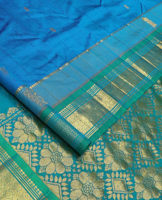 Blue Kanchipuram Silk Saree, Bedecked with Zari Buttas All Over Its Body, Complemented by Contrast One-Sided Border of Panner Sombu, Banaras, Muthu and Jaal Designs, Pallu Features Floral-Diamond Designs, and Comes Without a Blouse