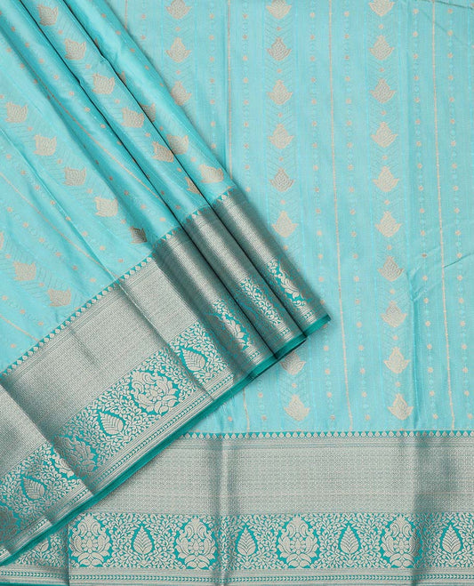 Turquoise art silk pavadai material, zari design with embossed contrast traditional zari border skirt, and contrast blouse