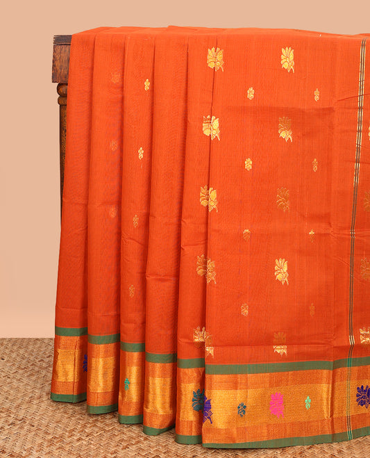 Orange Venkatagiri Cotton Saree, Ornamented with Buttas on Its Body, Complemented by a Contrast Zari and Thread Border, Gleaming Zari-Striped Pallu, and Comes Without a Blouse