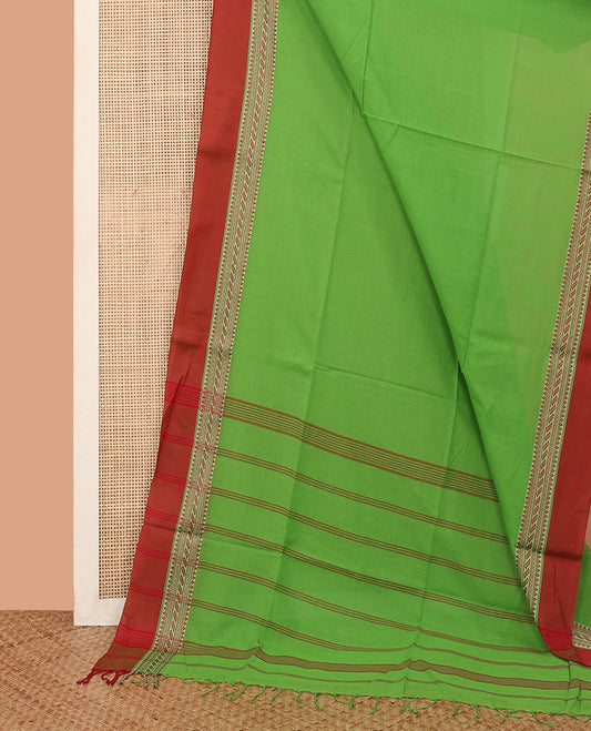 Parrot Green Plain Khadi Cotton Saree, Complemented by a Contrast Traditional Motifs Thread Woven Border, Pallu Features Stripes, and Comes Without a Blouse
