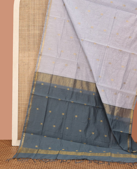 Grey Maheshwari Cotton Saree, Subtly Sparkled with Flower Buttas All Over Its Body, Subtly Woven Piping Border, Captivating Contrast Pallu Steeped with Buttas, and Paired with a Contrast Blouse