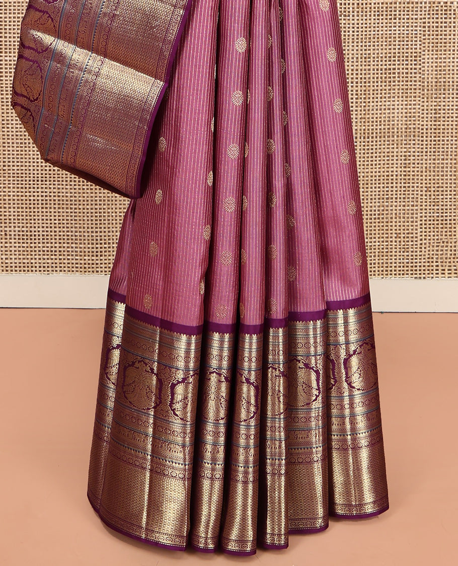 Pink Vasundhara Silk Saree, Elevated with Zari Stripes and Chakram Buttas All Over Its Body, Complemented by a Contrast Border of Rekku, Muthu, Kamalam and Mayil Kann Designs, Grand Geometric Patterned Pallu, and Paired with a Contrast Blouse