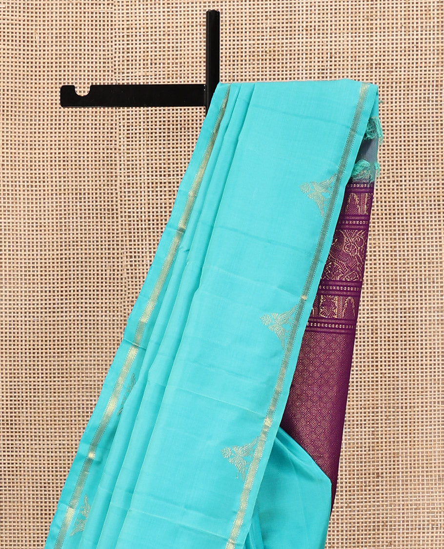 Blue Plain Kanchipuram Silk Saree, Subtle Zari Border of Muthu, Vanki, and Kili Designs, Captivating Contrast Pallu of Thilakam Mokku, Thazampoo Rekku, Iruthalai Pakshi, Kuthirai, and Jaal Designs, and Paired with a Contrast Blouse