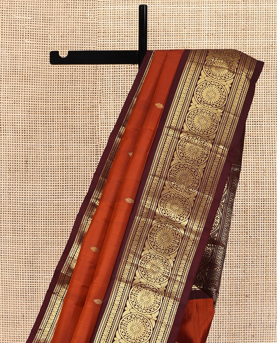 Orange Kanchipuram Silk Saree, Showcasing Zari Buttas All Over Its Body, Complemented by a Contrast Border of Muthu, Kathir, Kamalam, and Chakram Designs, Grand Jaal Pallu, and Paired with a Contrast Blouse