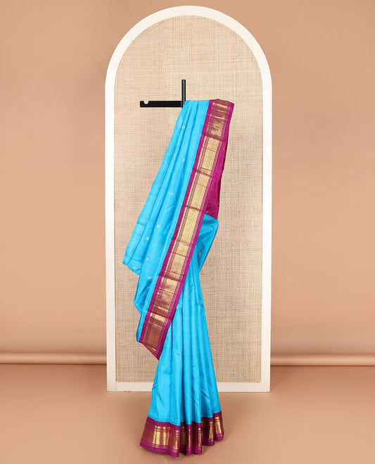 Blue zari buttas Kanchipuram silk saree, contrast korvai border of thilakam mokku, banaras, and jaal designs, and zari design pallu