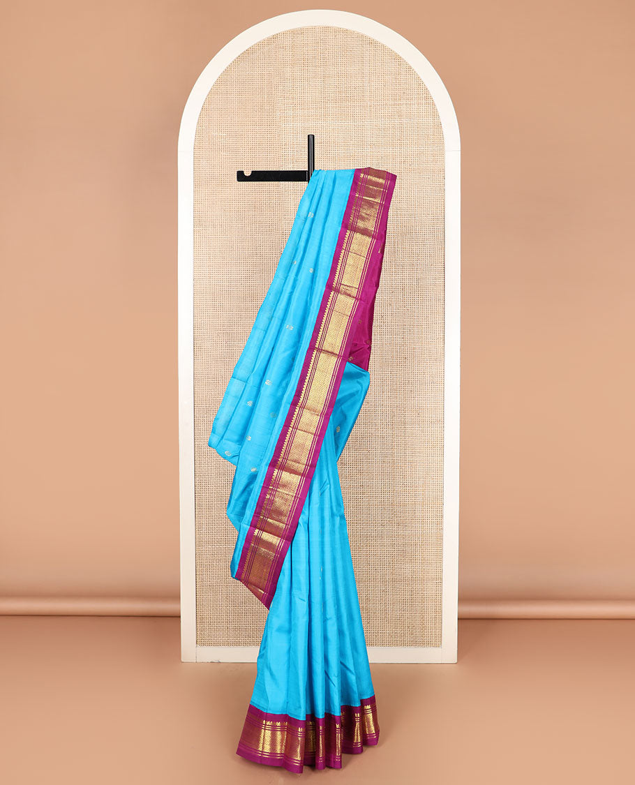 Blue zari buttas Kanchipuram silk saree, contrast korvai border of thilakam mokku, banaras, and jaal designs, and zari design pallu