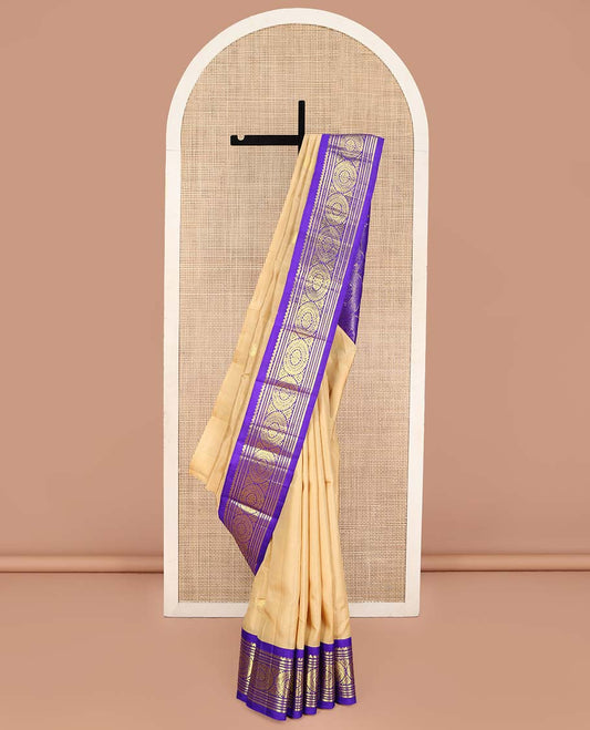 Sandal Kanchipuram Silk Saree, Sparsely Woven with Zari Buttas on Its Body, Complemented by a Contrast One-Sided Korvai Border of Salngai, Banaras, Muthu, and Chakram Designs, Pallu Steeped with Chakram Designs, and Comes Without a Blouse