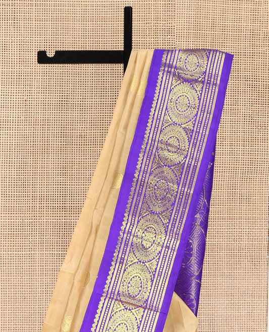 Sandal Kanchipuram Silk Saree, Sparsely Woven with Zari Buttas on Its Body, Complemented by a Contrast One-Sided Korvai Border of Salngai, Banaras, Muthu, and Chakram Designs, Pallu Steeped with Chakram Designs, and Comes Without a Blouse