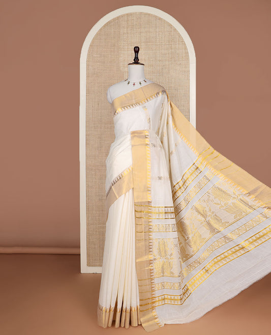 Cream zari design Kerala saree, zari temple border, and pallu features temple and floral designs