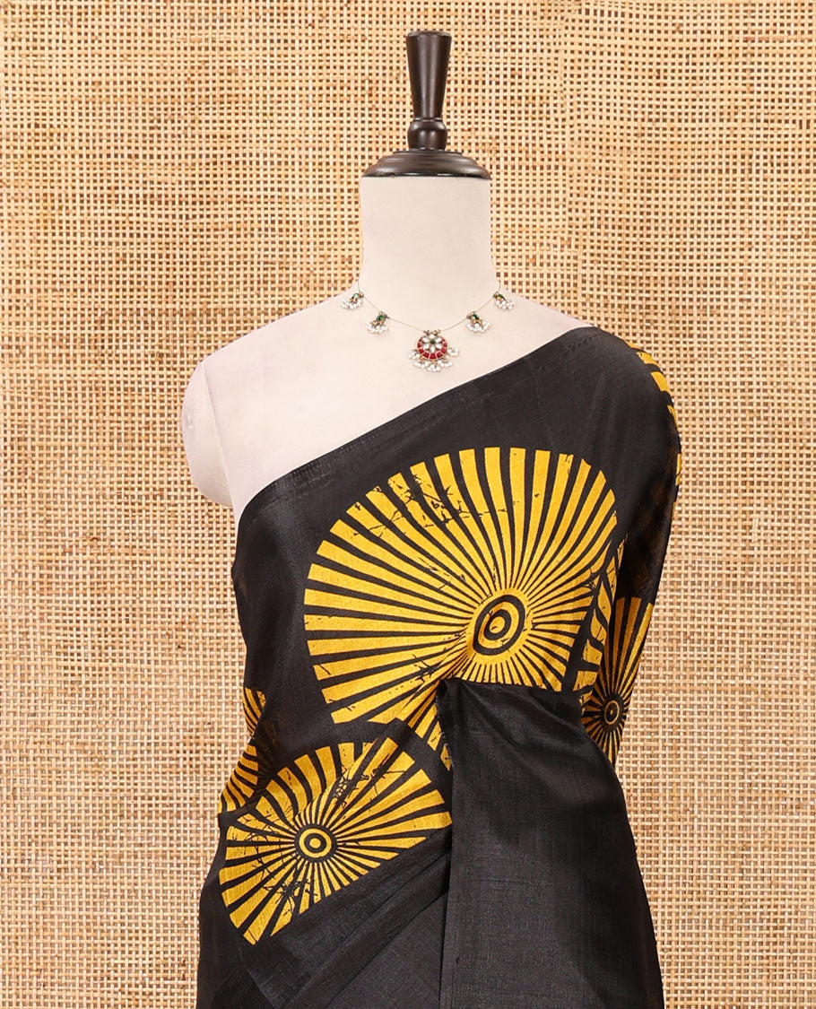 Black-base plain body khadi cotton saree with batik-style yellow-color radiant sunburst design on its border & pallu, plain black blouse