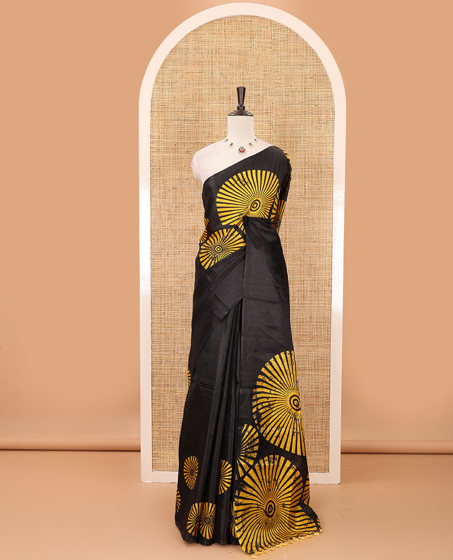 Black-base plain body khadi cotton saree with batik-style yellow-color radiant sunburst design on its border & pallu, plain black blouse