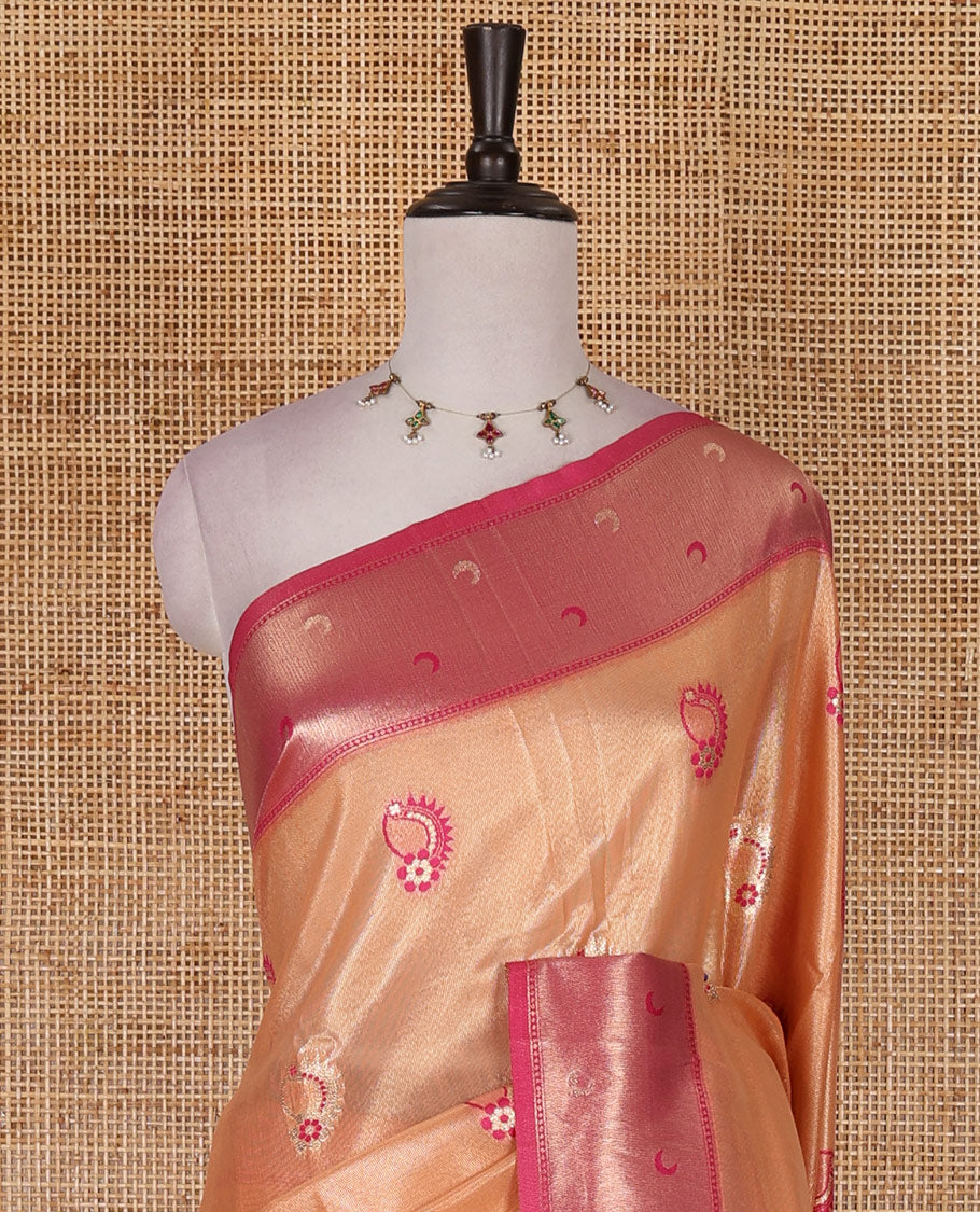 Peach antique buttas tissue silk saree, contrast satin zari border of half-moon motifs, pallu of temple design pallu, and contrast butta blouse