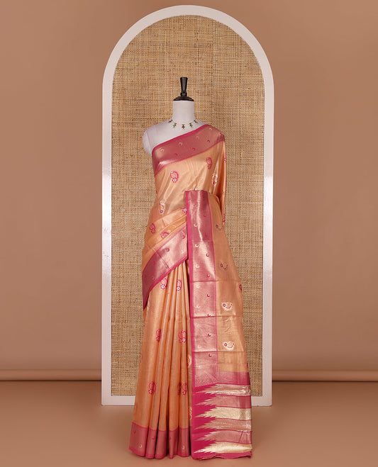 Peach antique buttas tissue silk saree, contrast satin zari border of half-moon motifs, pallu of temple design pallu, and contrast butta blouse