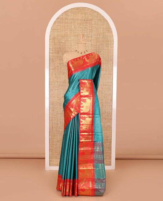 Peacock green zari checked semi-taffeta saree, contrast satin temple border of elephant motifs, striped pallu, and a contrast striped blouse