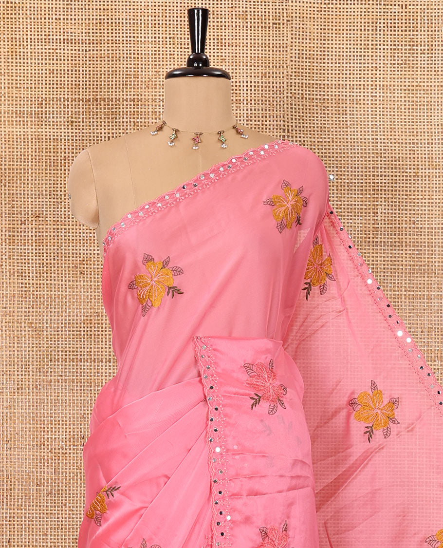 Pink floral motifs embroidered rangoli chiffon saree with mirror work border, embroidered pallu, and a contrast intricate scallop design embroidered blouse