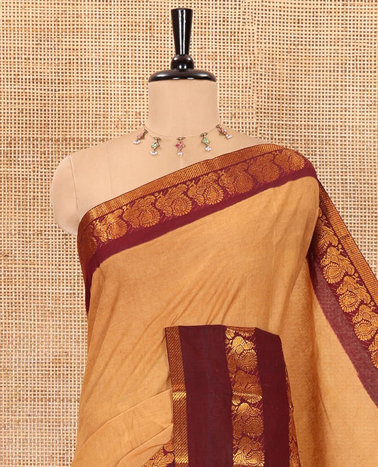 Sandal plain sungudi cotton saree with contrast traditional border of peacocks, zari striped pallu, and a contrast zari checked blouse