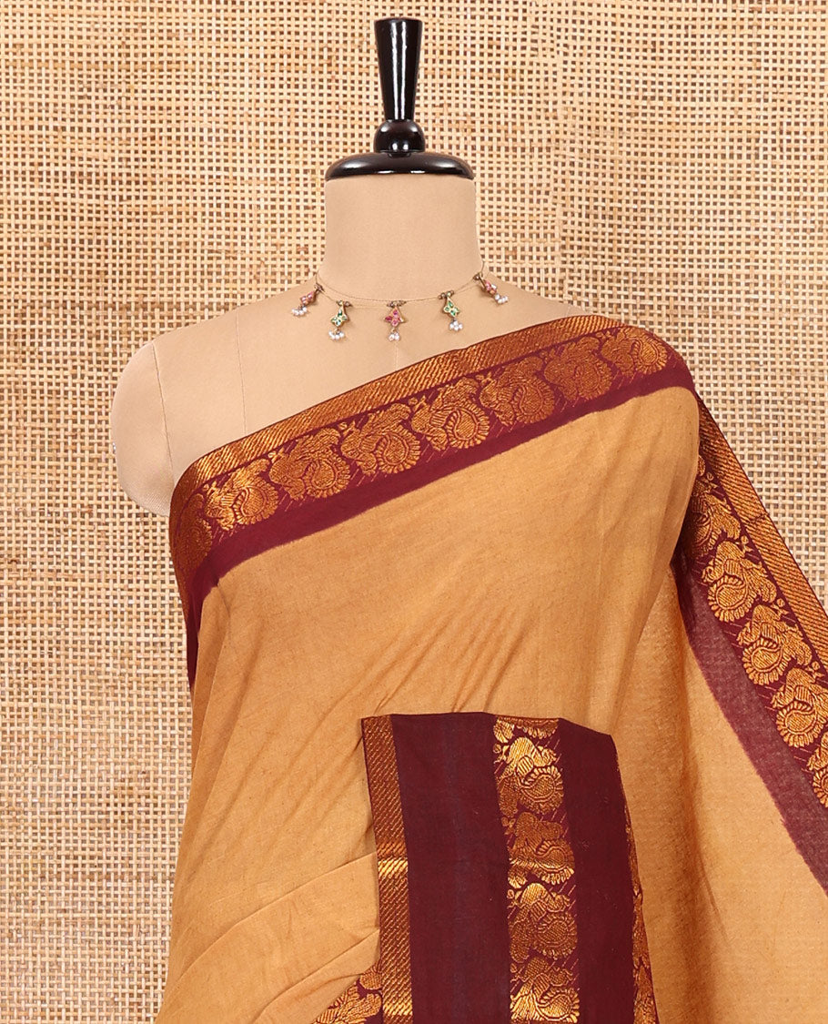 Sandal plain sungudi cotton saree with contrast traditional border of peacocks, zari striped pallu, and a contrast zari checked blouse