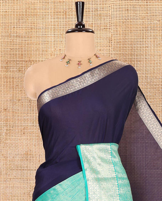 Navy Blue and Rama Half-And-Half Style Art Crepe Saree Richly Detailed with Plain and Jacquard Design, Complemented by a Contrast Border of Traditional Zari Designs, Pallu Featuring Zari Stripes, and Paired with a Matching Blouse