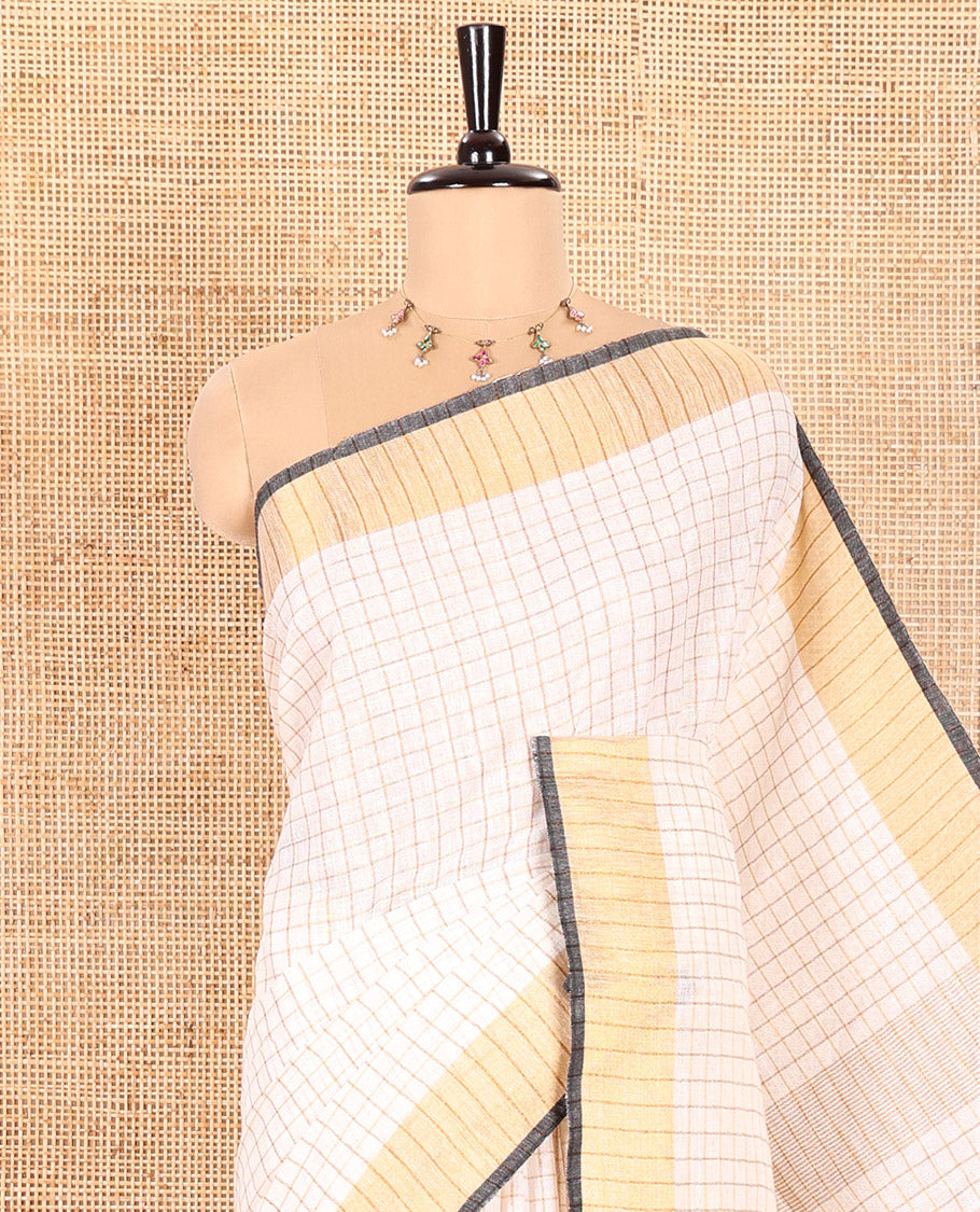 Cream and Black Linen Saree Sparsely Sparkled with Checks, Subtly Designed Zari Border, Zari Striped Pallu, and Paired with a Contrast Blouse